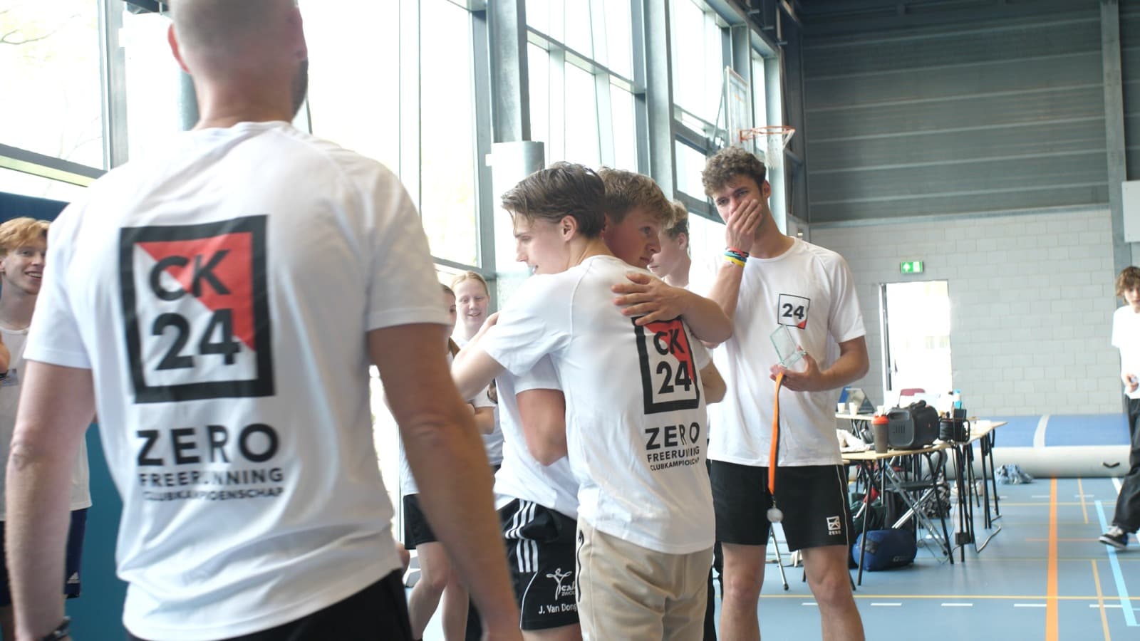 Deelnemers van ZERO Freerunning steunen elkaar na een wedstrijdmoment